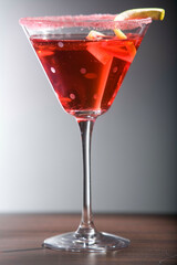 Glass of cocktail with a lemon peel