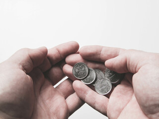 Coins in the palm of your hand. Poverty and depreciation. Minimum wage.