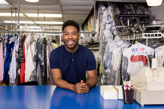 Black Drycleaner business owner in his store behind counter