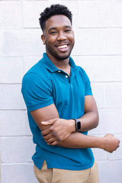 Portrait of a happy young man standing outside looking at camera