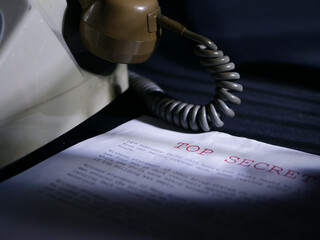 Obraz premium Top secret document in dark room with vintage phone