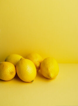 Close up of whole lemons on yellow background