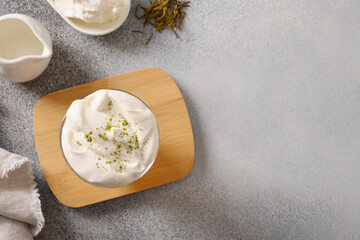 Cheese Tea with creamy foam topped matcha powder on gray background. Asian trendy beverage. Close up. Copy space.