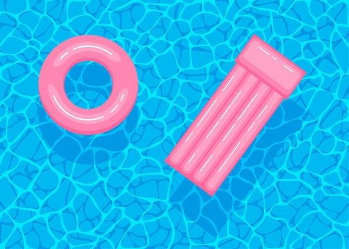 Swimming pool with floating inflatable pink circle and air mattress. Top view