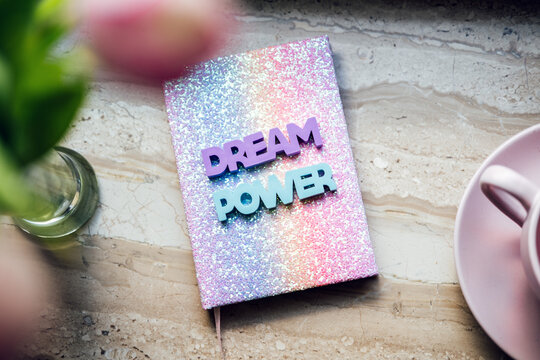 Big dream word on pop color rainbow unicorn shiny notepad and tulips on wooden table. Motivation quote, inspiration, positive affirmation - Powered by Adobe