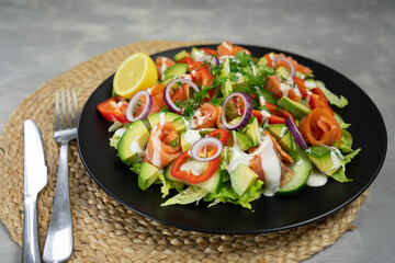 Vegetable salad with smoked salmon and fresh vegetables.