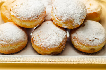 Berliner Pfannkuchen, a German donut, traditional yeast dough deep fried filled with chocolate cream and sprinkled with powdered sugar