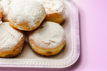 Berliner Pfannkuchen, a German donut, traditional yeast dough deep fried filled with chocolate cream and sprinkled with powdered sugar