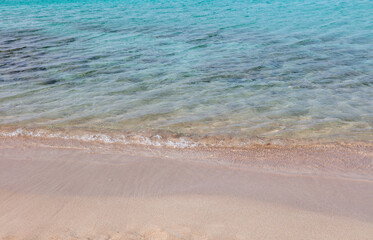 Fototapeta na wymiar Empty sandy beach in Greece, overhead. Sea water touch wet white sand, copy space. Summer holiday