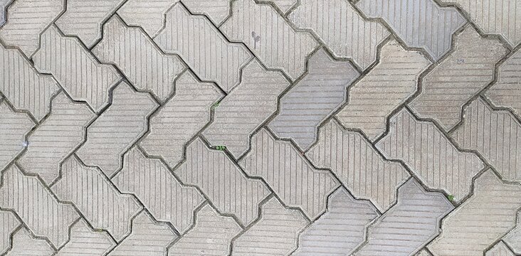 dirty grey color interior and exterior brick block tile stone or cobblestone with copy space. Abstract geometric architecture background texture pattern. Beautiful horizontal close up macro top view.