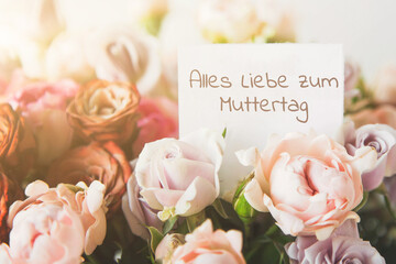 beautiful bright bouquet of colorful roses with white card with the inscription happy mothers day...