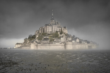misty morning at mont saint michel in normandy, france