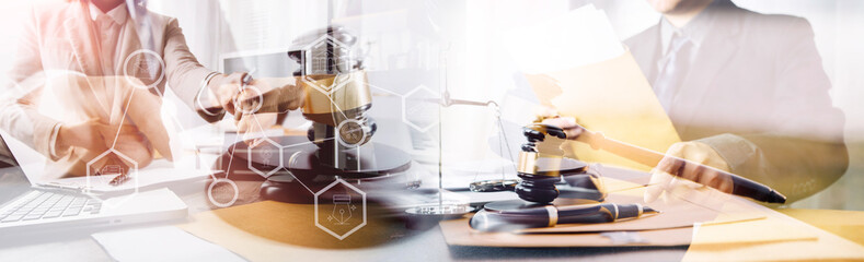 Business and lawyers discussing contract papers with brass scale on desk in office. Law, legal services, advice, justice and law concept picture with film grain effect