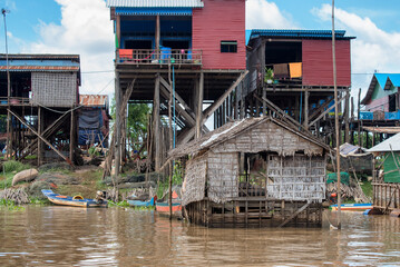 Fototapeta na wymiar KOMPO KHLEANG, CAMBODIA - JULY 29: Old homes and new homes at Kompo Khleang on Tonle Sap Lake in Cambodia on July 29, 2016.