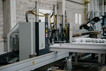 Factory for aluminum and PVC windows and doors production. Details industrial equipment.