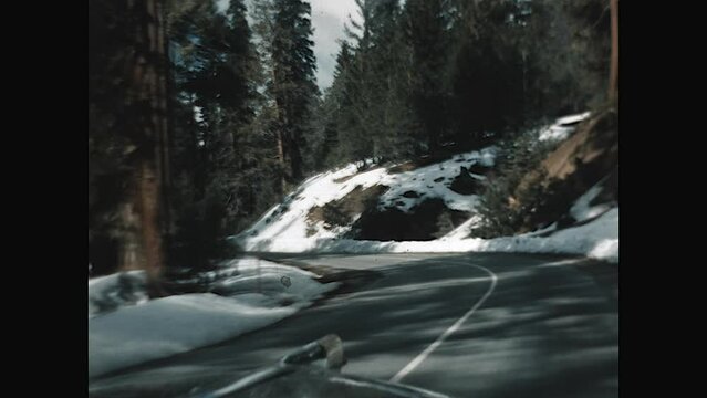 Driving Yosemite Winter 1957 - POV of a car driving through the snow covered roads of Yosemite  