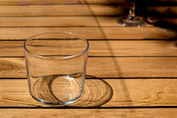 An empty glass on a wooden table