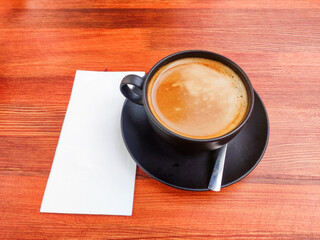 cup of coffee on wooden table