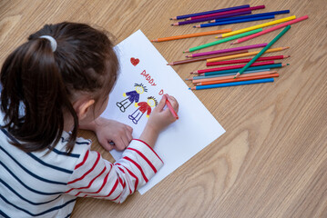 little girl drawing her gay family