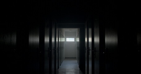 Camera movement dark corridor with doors. Door handles with locks. At the end of the tunnel there...