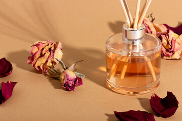 reed diffuser with flowers. Incense sticks for the home with a floral scent with hard shadows. The...