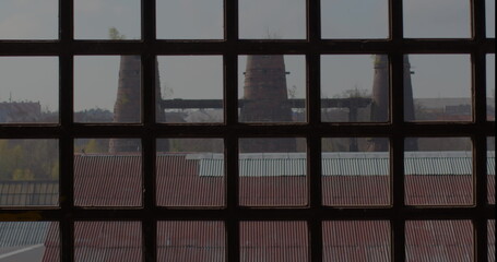 View of the prison from a barred window. The roof of the camp barracks, the sky. Awareness of the limitation of freedom. Protection of the window opening from the use of climbing.