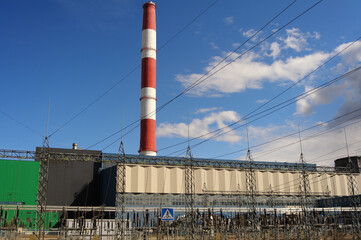 Fototapeta na wymiar Factory chimney pipe with electric wires on sunny day