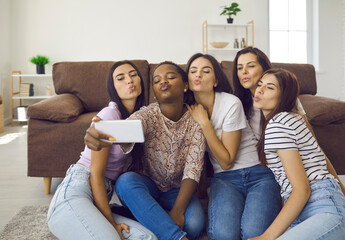 Mwah. Girls take group selfie to keep good memories and capture funny moment with friends. Happy...