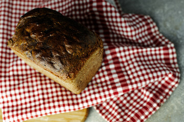 black malt rye bread on a checkered tablecloth