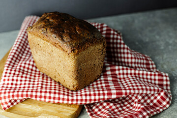 black malt rye bread on a checkered tablecloth