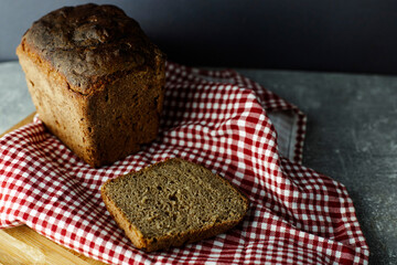 black malt rye bread on a checkered tablecloth