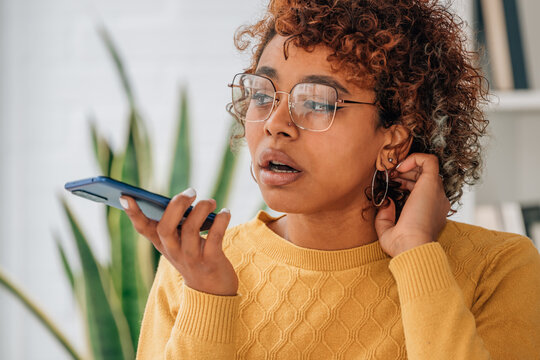 african american girl with mobile phone sending voice message