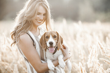 Attractiive young woman outdoors with her pet. Owner and dog together. Friends forever. Lady and...