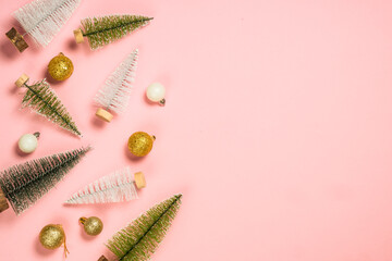 Christmas decorations at pink background. Christmas fir tree, present box and holiday decorations. Top view with copy space.