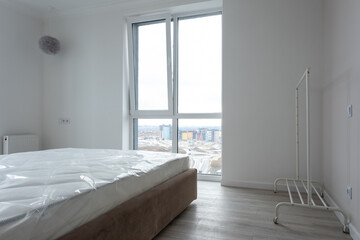 Interior of comfortable modern bedroom. Moving to a new apartment. Renting a new home. Summer vacation