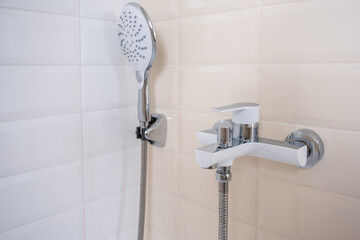 Interior of a modern shower head in a bathroom at home. Modern bathroom design. White bath, shower...