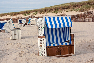 Typical beach chair in Sylt with dunes in the background