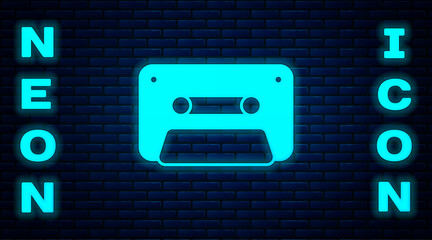Glowing neon Retro audio cassette tape icon isolated on brick wall background. Vector