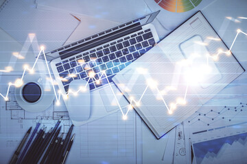 Multi exposure of forex chart drawing over table background with computer. Concept of financial research and analysis. Top view.