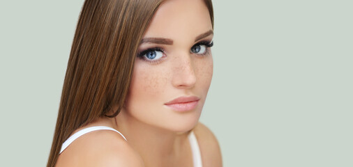 Freckles. Portrait of a young blond girl with blue eyes