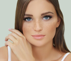 Freckles. Portrait of a young blond girl with blue eyes