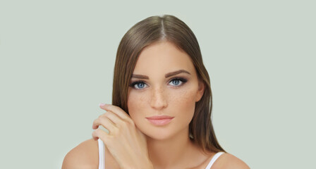 Freckles. Portrait of a young blond girl with blue eyes