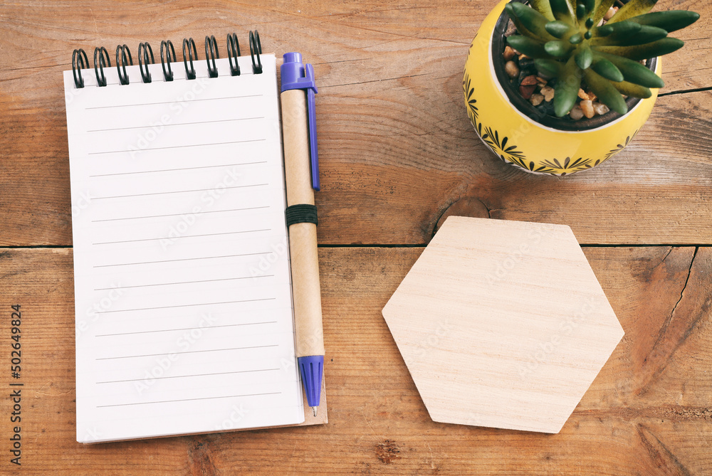 Fototapete top view image of open notebook with blank pages on wooden desk. ready for adding text or mockup.