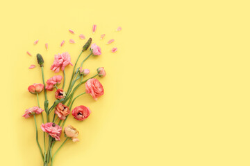 Top view image of pink flowers composition over yellow background