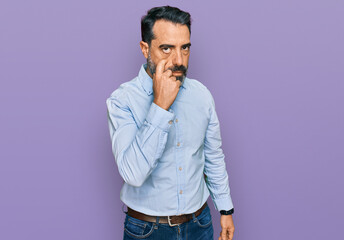 Middle aged man with beard wearing business shirt pointing to the eye watching you gesture, suspicious expression