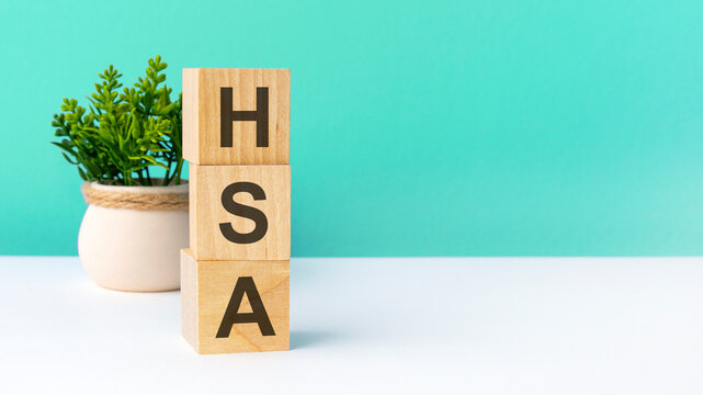 hsa - word from wooden blocks with letters, green background. copy space available
