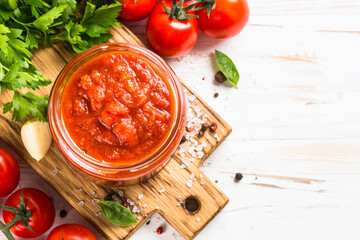Tomato sauce. Traditional italian tomato sauce with herbs and spices at white kitchen table. Top...