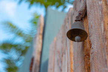 Metal vintage doorbell. Closeup view of a doorbell hanging on the door.