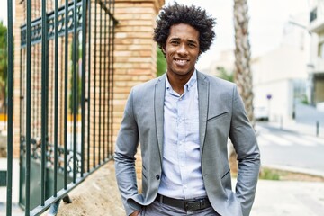 Young african american businessman smiling happy standing at the city.