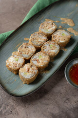 Hot tempura sushi on a gray dish close-up